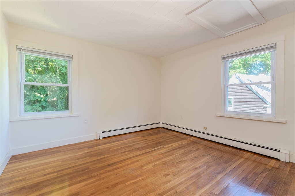 660 Jerusalem Road, Unit 4 Cohasset, MA 02025 - Photo 11 of 20 a view of an empty room with wooden floor and a window