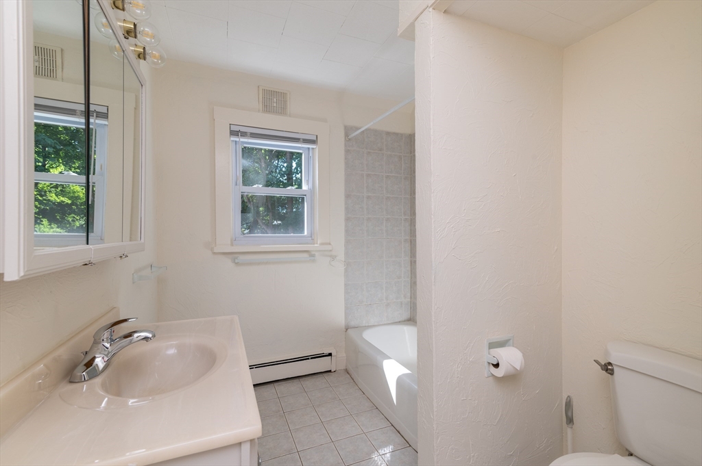 660 Jerusalem Road, Unit 4 Cohasset, MA 02025 - Photo 15 of 20 a bathroom with a tub sink and mirror