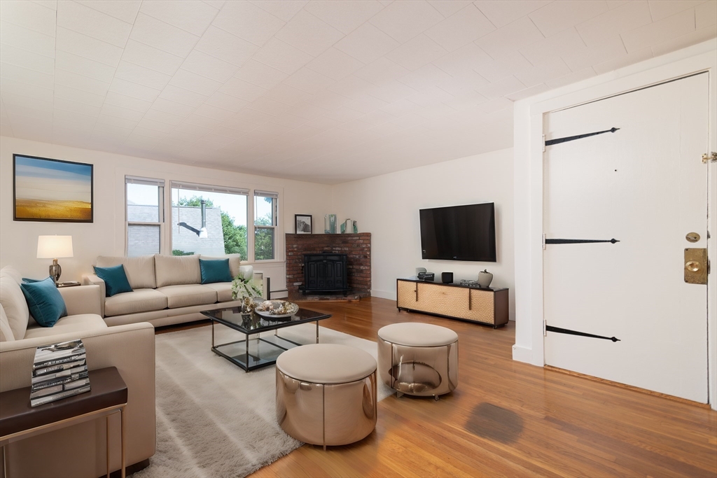660 Jerusalem Road, Unit 4 Cohasset, MA 02025 - Photo 7 of 20 a living room with furniture and a flat screen tv