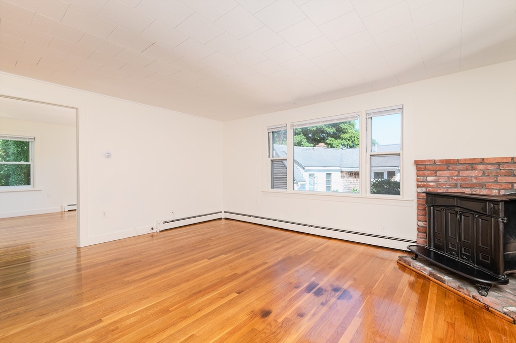 660 Jerusalem Road, Unit 4 Cohasset, MA 02025 - Photo 9 of 20 an empty room with wooden floor and windows