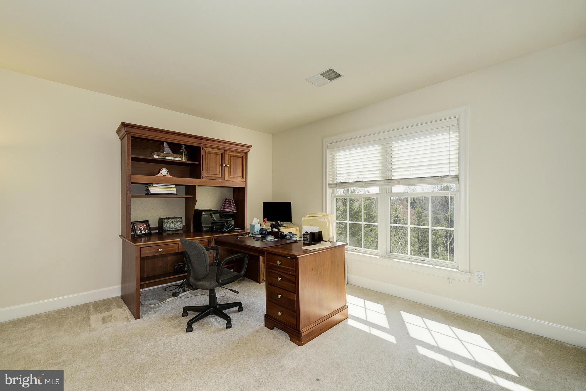 10412 Grey Fox Road Potomac, MD 20854 - Photo 21 of 30 a view of a workspace with furniture and a window