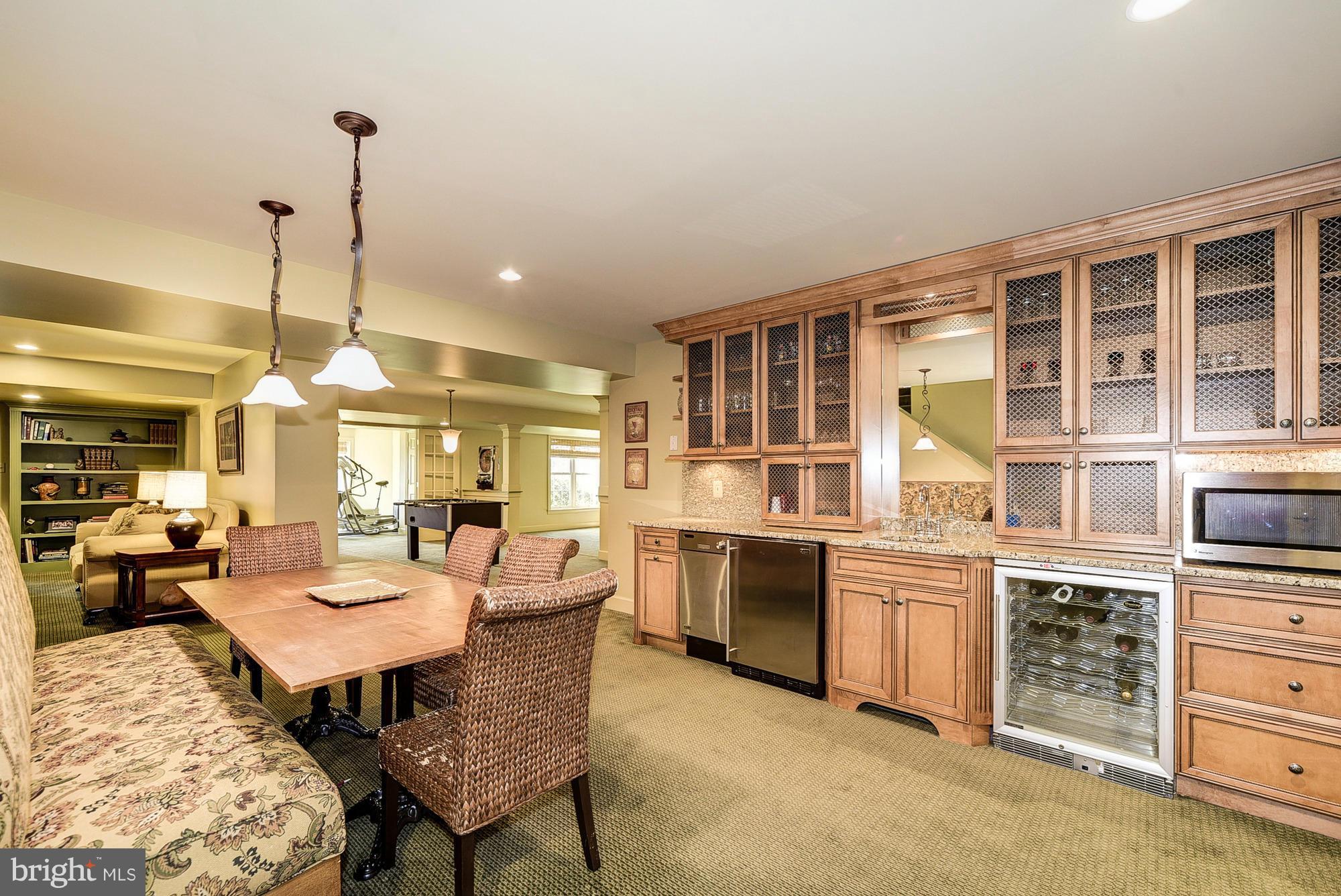 10412 Grey Fox Road Potomac, MD 20854 - Photo 23 of 30 a dining room with furniture a chandelier and kitchen view