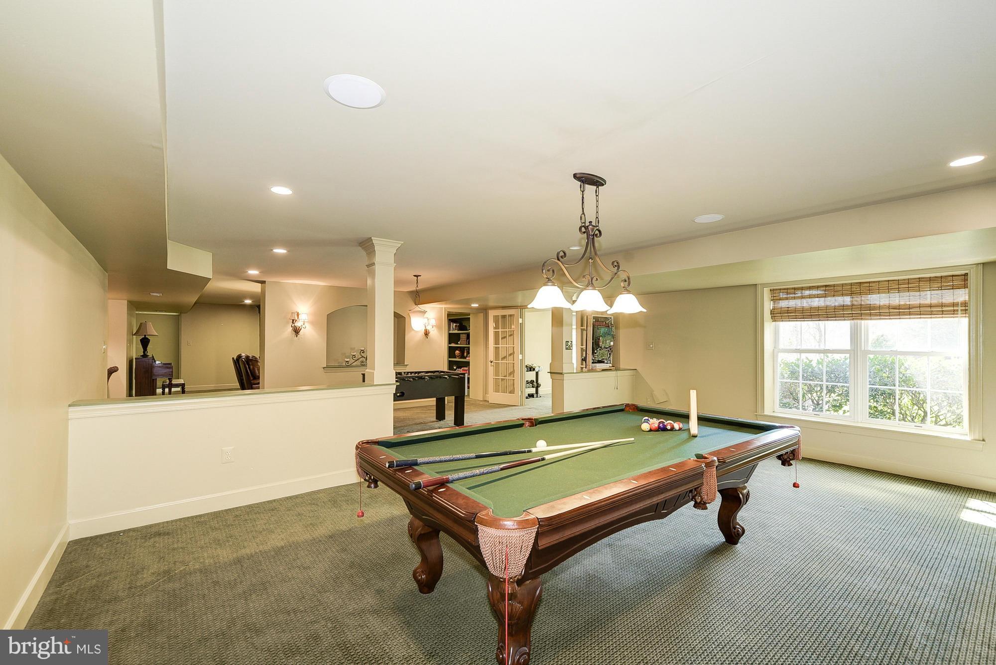 10412 Grey Fox Road Potomac, MD 20854 - Photo 25 of 30 a room with pool tables and a chandelier