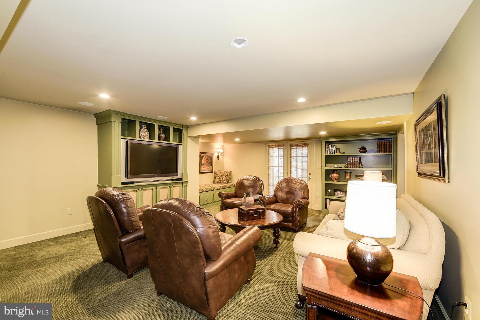 10412 Grey Fox Road Potomac, MD 20854 - Photo 27 of 30 a living room with furniture and a flat screen tv