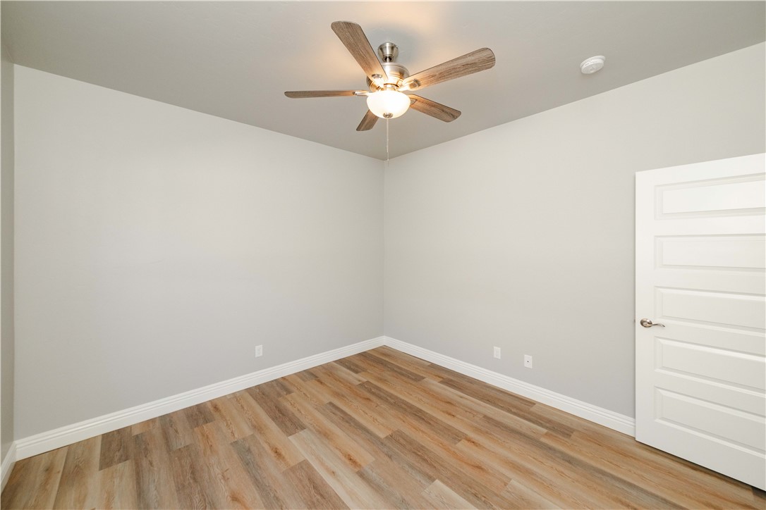 3640 North Kenneth Road Kingman, AZ 86409 - Photo 14 of 44 Spare room featuring light wood-style flooring and ceiling fan