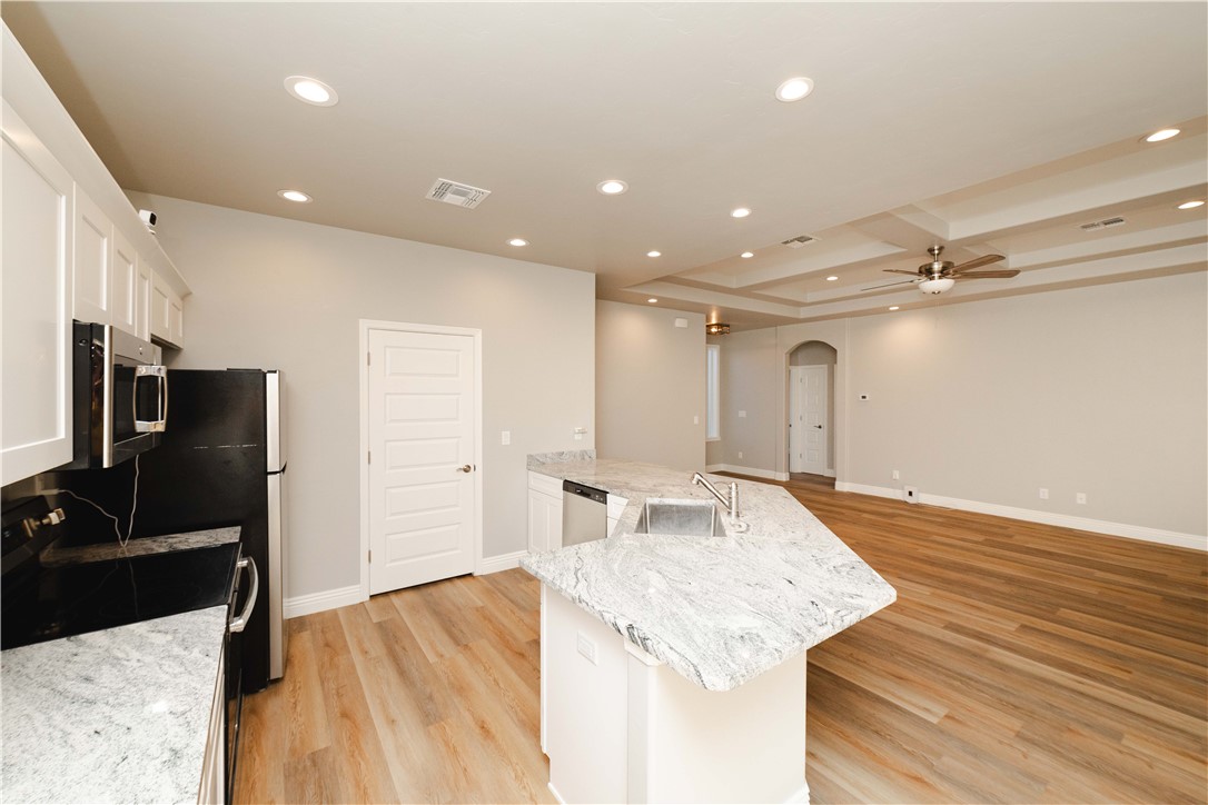 3640 North Kenneth Road Kingman, AZ 86409 - Photo 16 of 44 Kitchen with a peninsula, recessed lighting, arched walkways, white cabinets, and stainless steel appliances