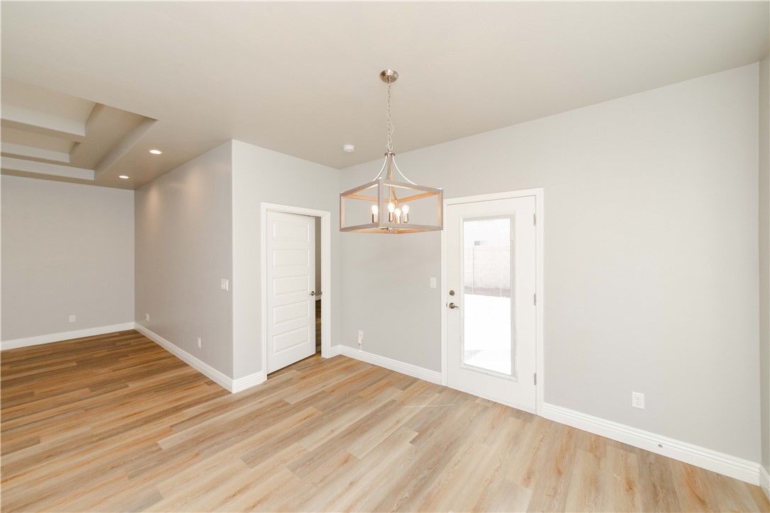 3640 North Kenneth Road Kingman, AZ 86409 - Photo 20 of 44 Unfurnished dining area with light wood-type flooring, a chandelier, and recessed lighting
