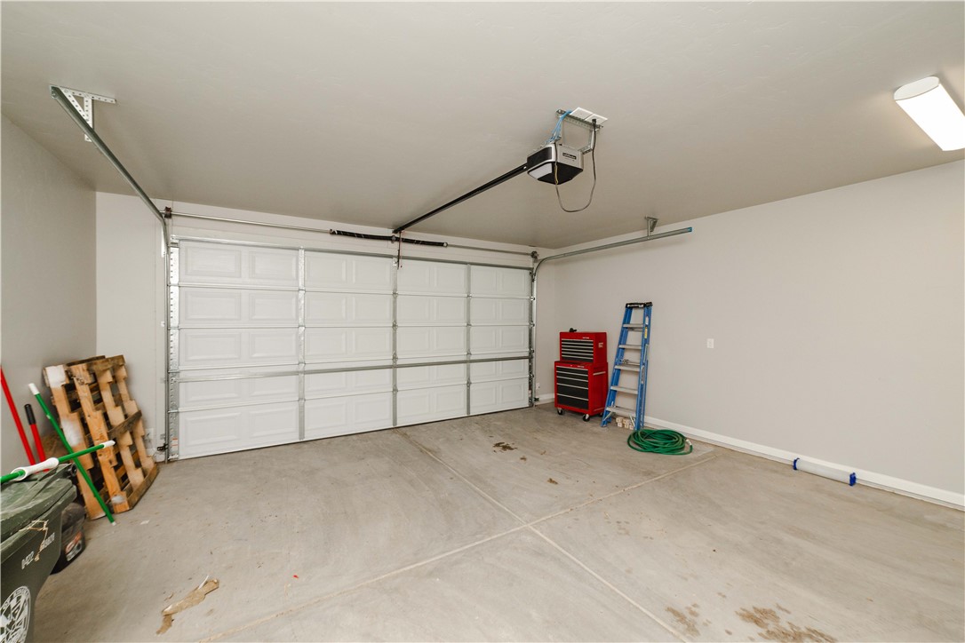3640 North Kenneth Road Kingman, AZ 86409 - Photo 28 of 44 Garage with a garage door opener and baseboards