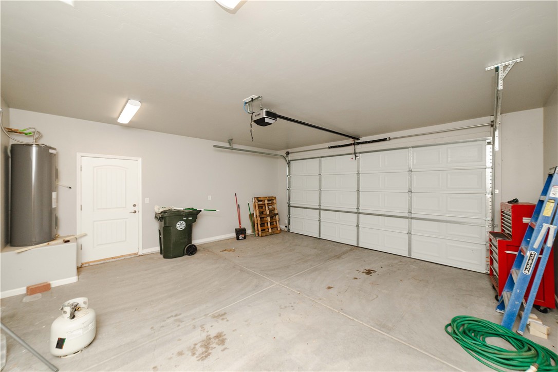 3640 North Kenneth Road Kingman, AZ 86409 - Photo 29 of 44 Garage featuring electric water heater and a garage door opener