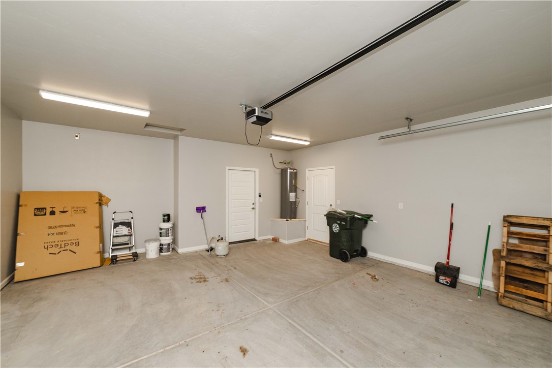 3640 North Kenneth Road Kingman, AZ 86409 - Photo 30 of 44 Garage with baseboards and water heater