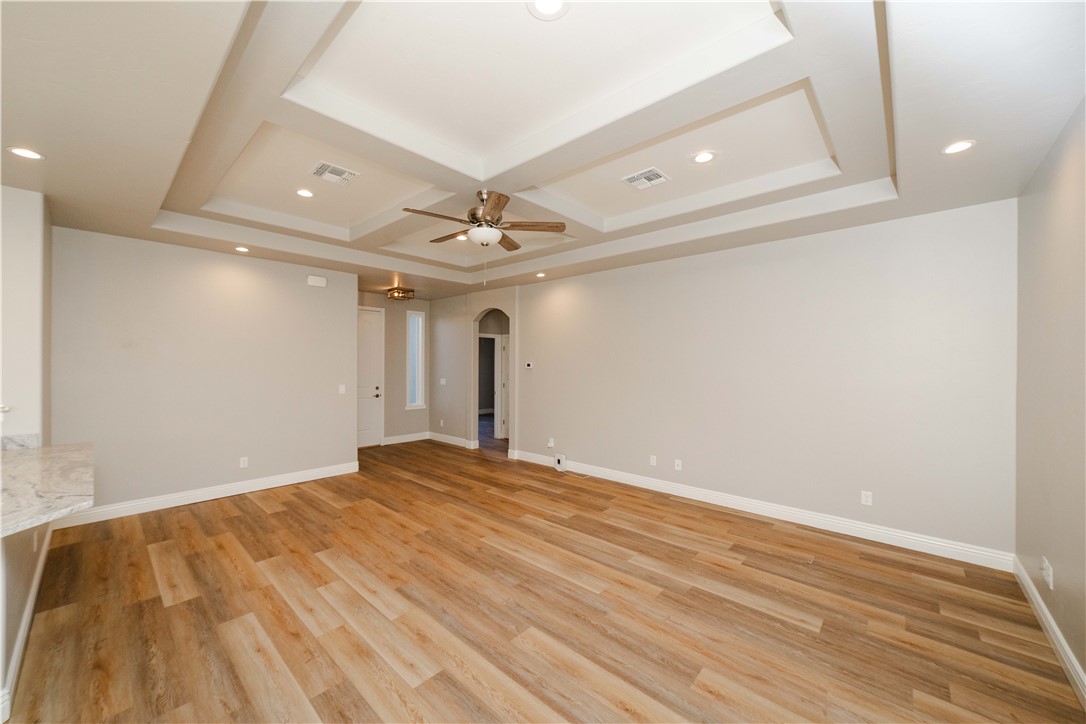 3640 North Kenneth Road Kingman, AZ 86409 - Photo 5 of 44 Spare room with arched walkways, recessed lighting, light wood-type flooring, coffered ceiling, and a ceiling fan