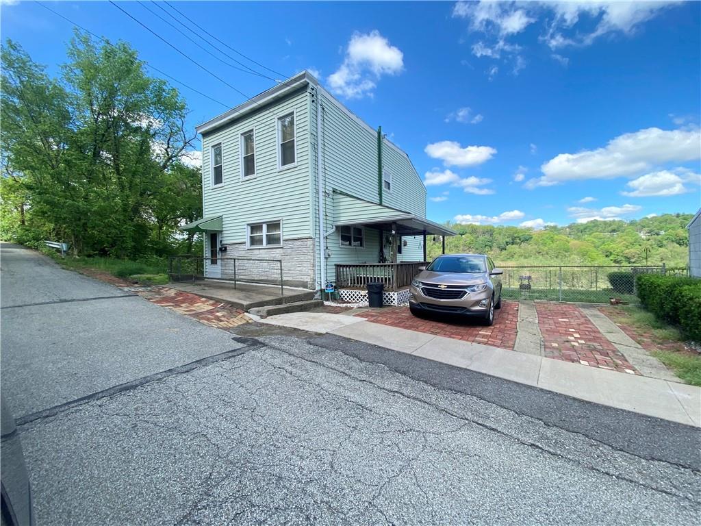 141 Overbeck Street Pittsburgh, PA 15212 - Photo 1 of 20 a front view of a house with a garden