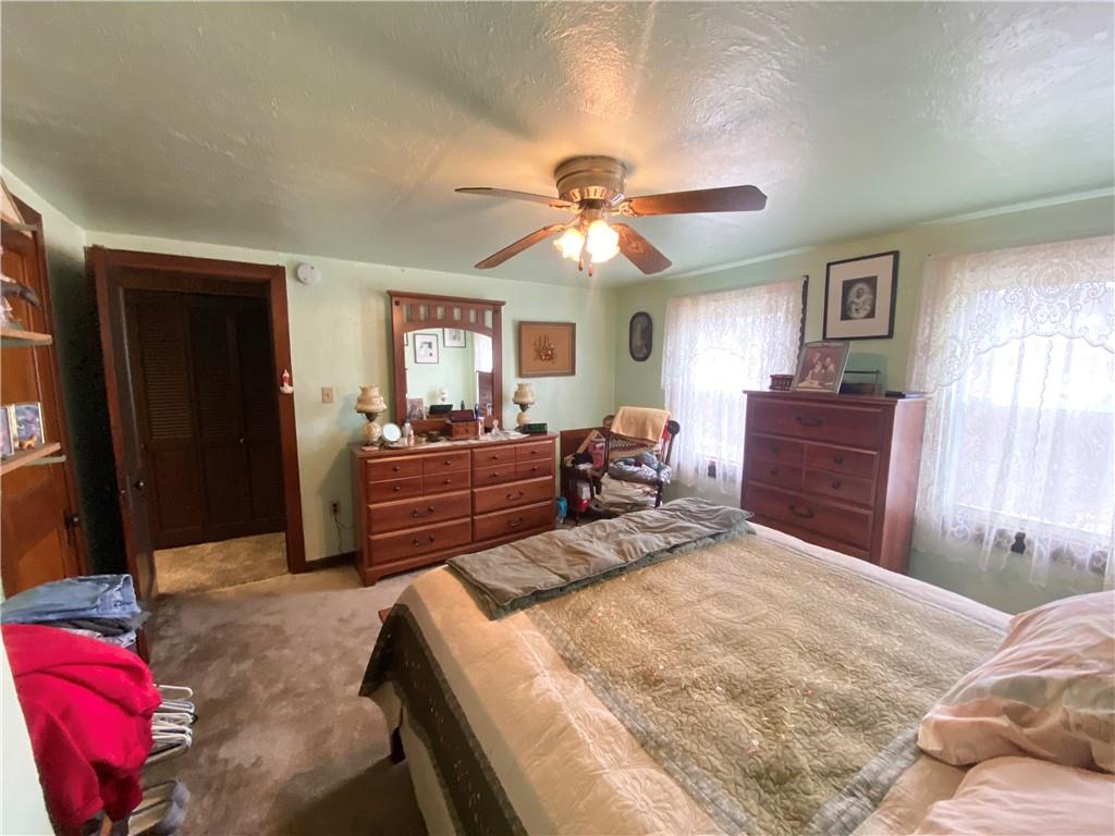 141 Overbeck Street Pittsburgh, PA 15212 - Photo 11 of 20 a bedroom with a bed and a chandelier
