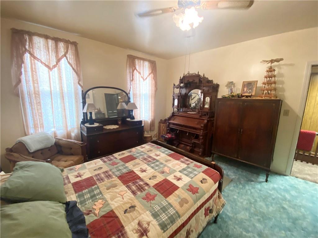 141 Overbeck Street Pittsburgh, PA 15212 - Photo 14 of 20 a bed sitting in a bedroom next to a window with pc on the dresser