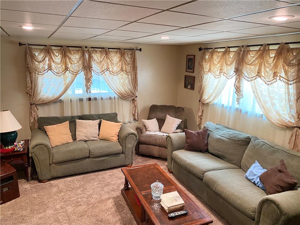 141 Overbeck Street Pittsburgh, PA 15212 - Photo 3 of 20 a living room with furniture a large window and a chandelier