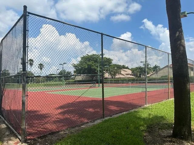 a view of a room with furniture and large windows