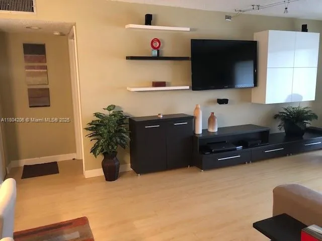 a kitchen with a refrigerator and a wooden cabinets