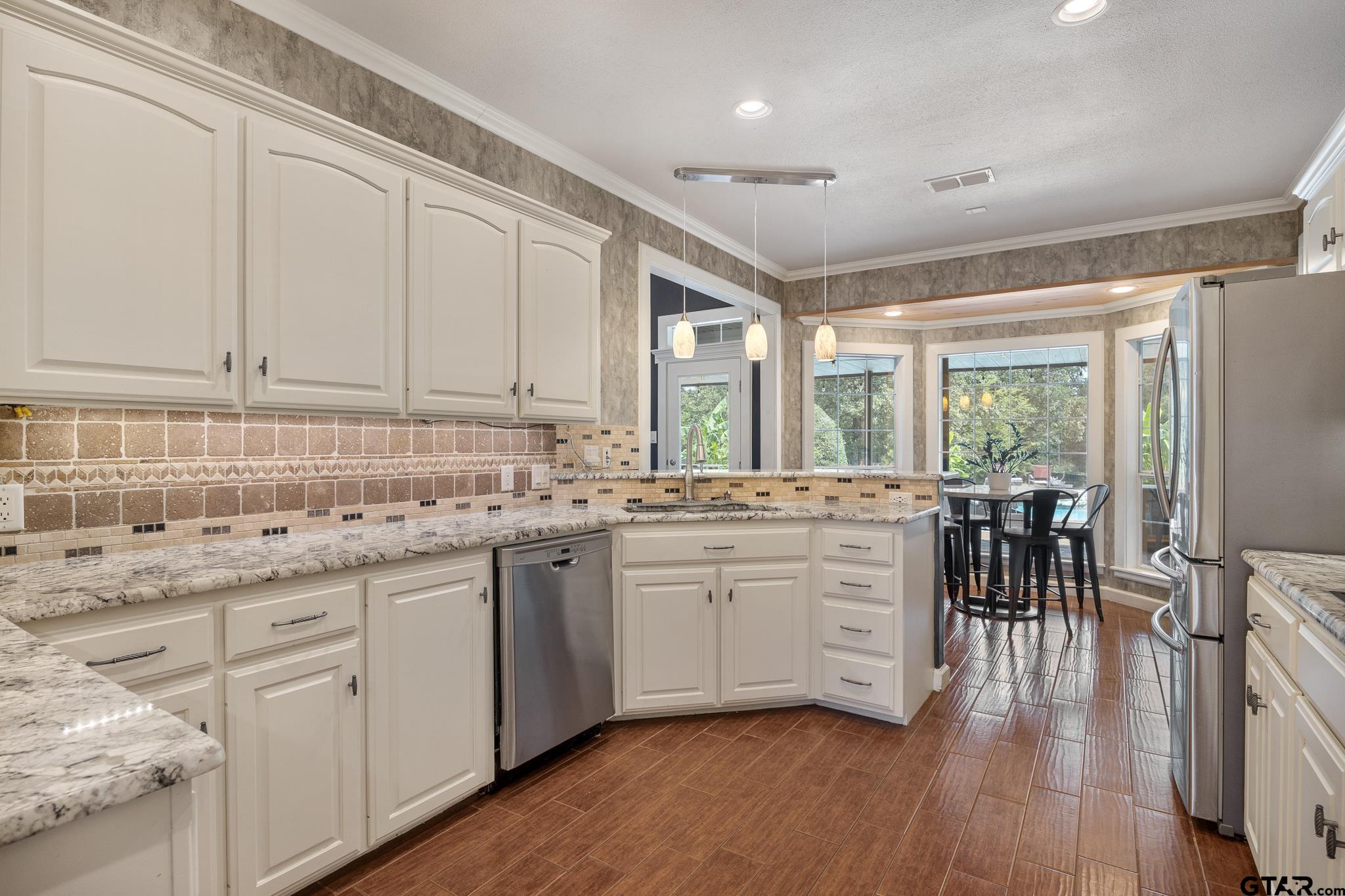 344 Antler Road Longview, TX 75605 - Photo 11 of 45 a kitchen with sink cabinets and wooden floor