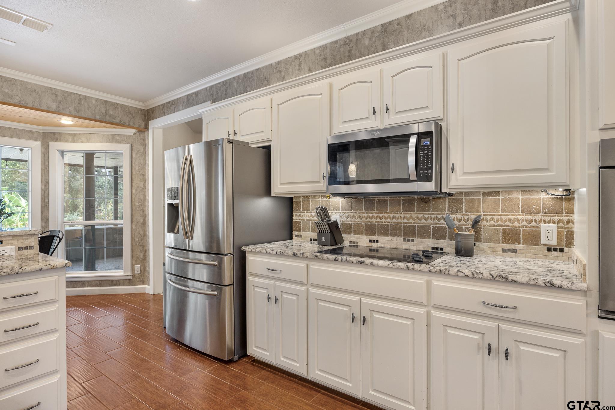 344 Antler Road Longview, TX 75605 - Photo 12 of 45 a kitchen with stainless steel appliances granite countertop a refrigerator microwave and sink