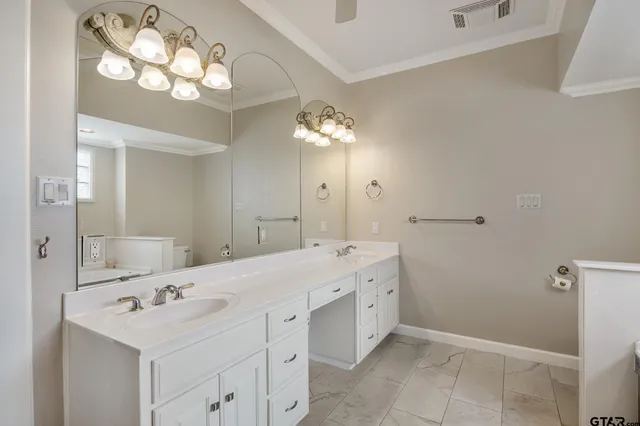 a bathroom with a sink vanity and a mirror