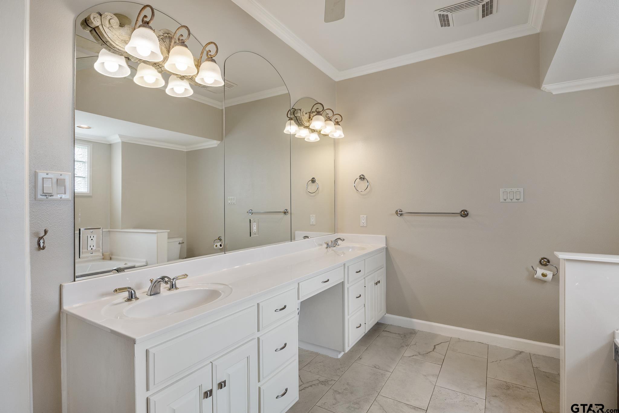 344 Antler Road Longview, TX 75605 - Photo 18 of 45 a bathroom with a sink vanity and a mirror