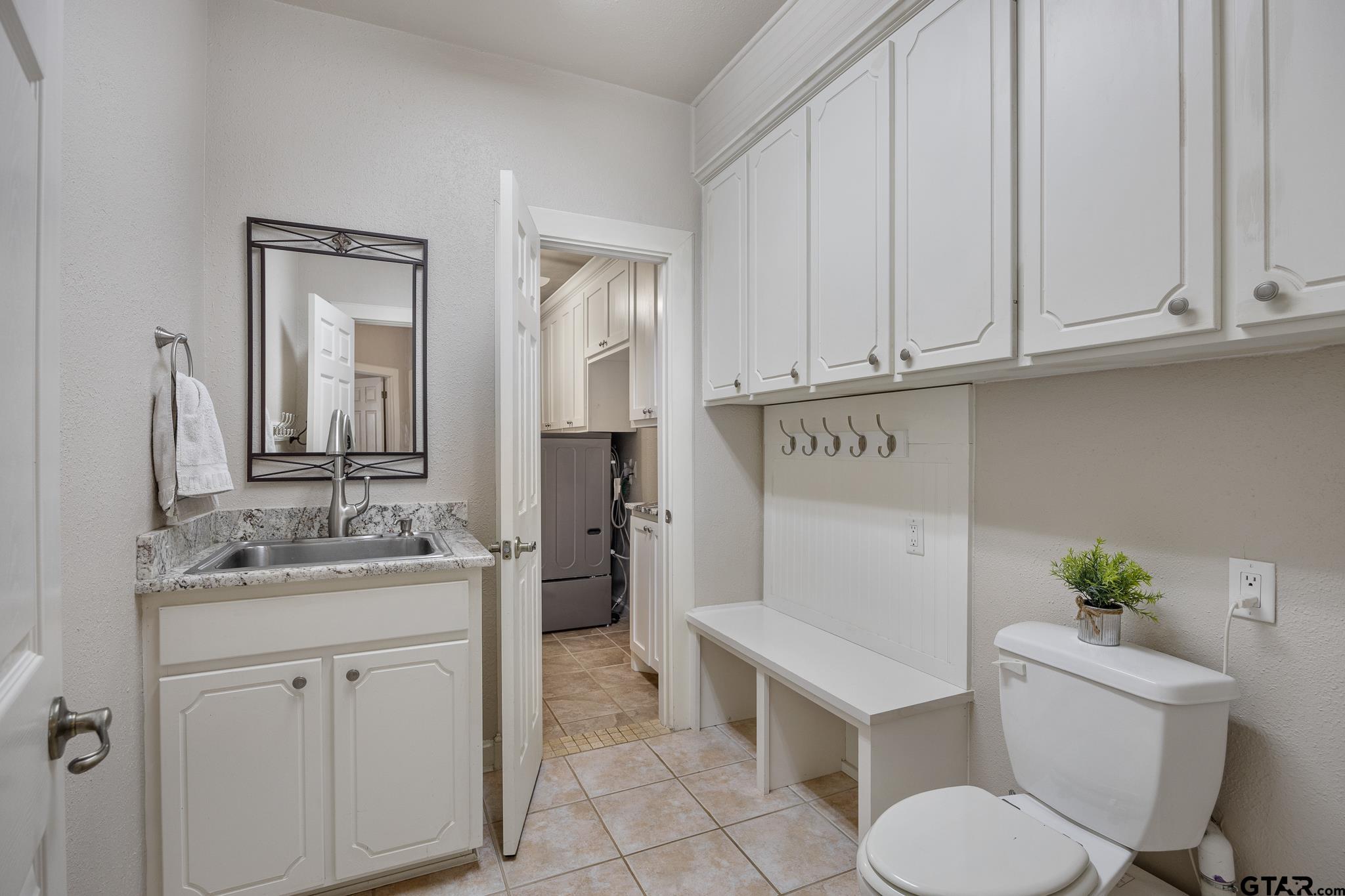 344 Antler Road Longview, TX 75605 - Photo 21 of 45 a bathroom with a granite countertop toilet sink and mirror