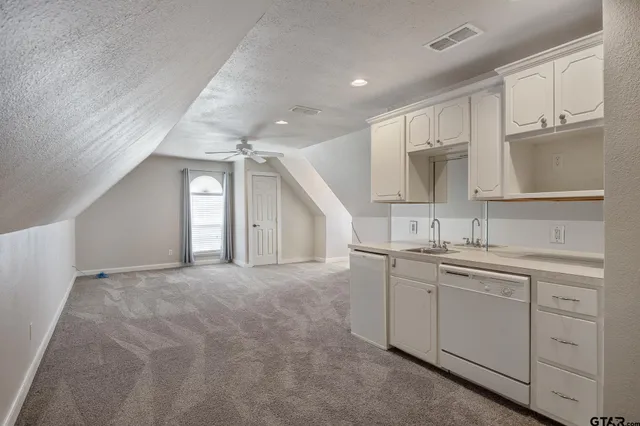 a view of a kitchen with sink and cabinets