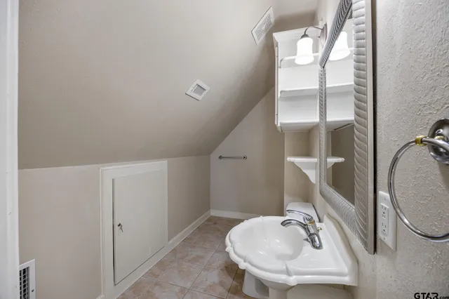 a bathroom with a sink and mirror