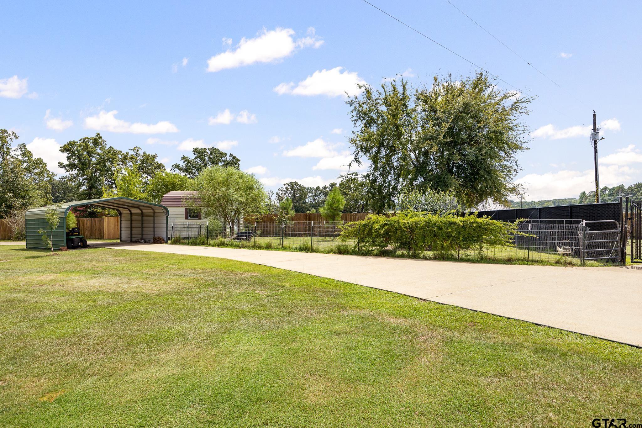 344 Antler Road Longview, TX 75605 - Photo 40 of 45 a view of a swimming pool and a yard