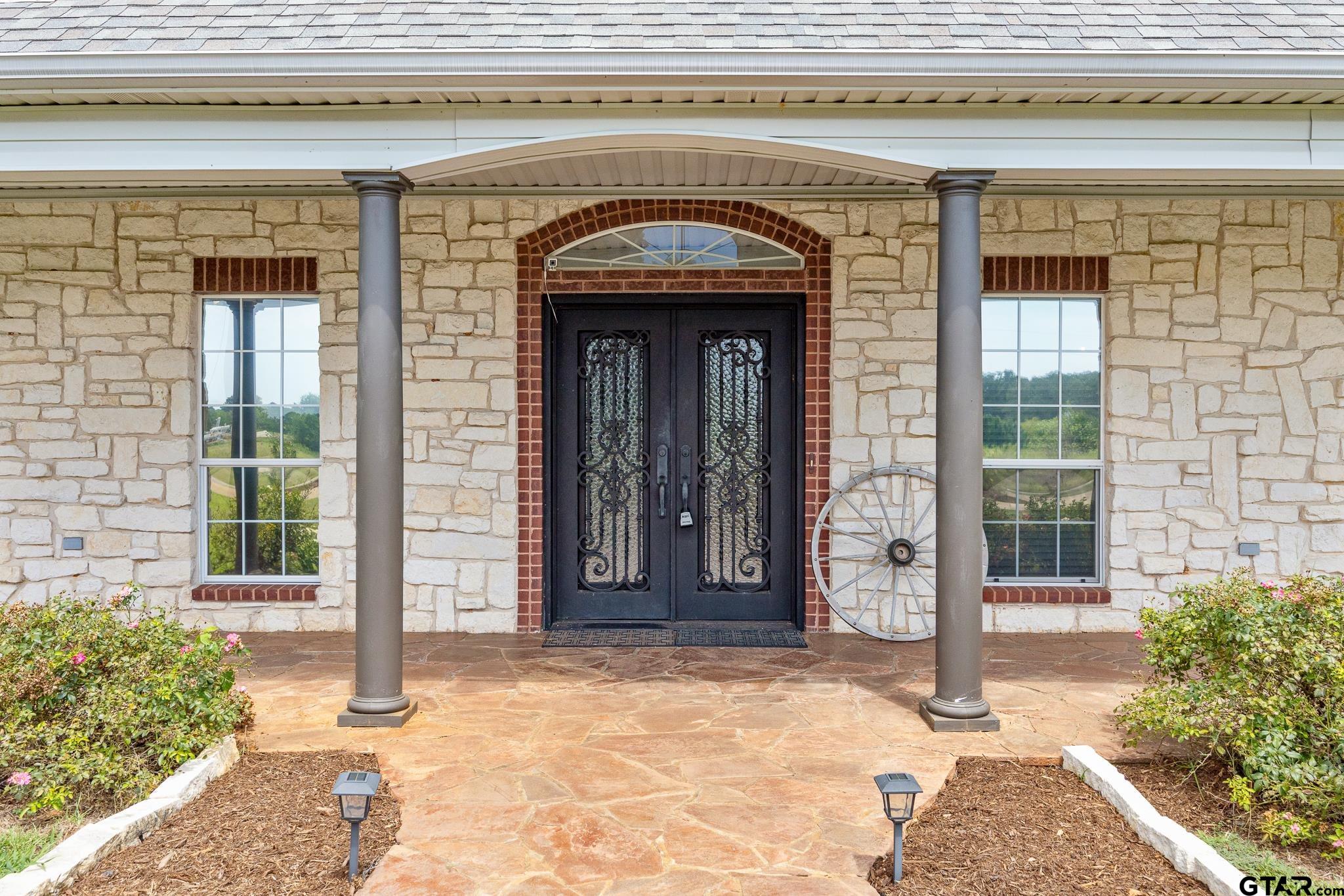 344 Antler Road Longview, TX 75605 - Photo 4 of 45 a view of entrance with a building and potted plants