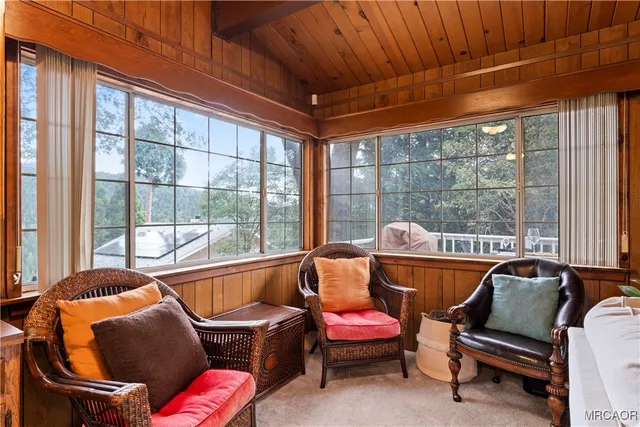 a living room filled with furniture and a floor to ceiling window