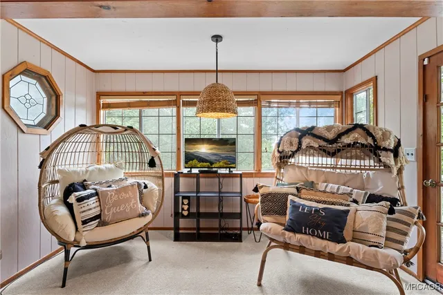 a living room with furniture a window and a chandelier