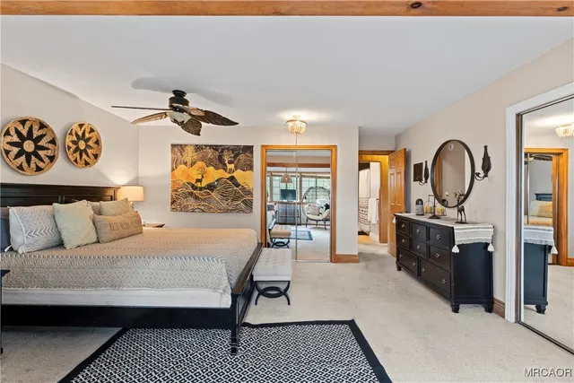 a bedroom with a large bed a flat tv screen and dresser