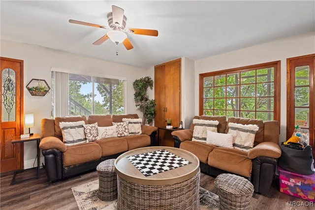 a living room with furniture and a large window with garden view