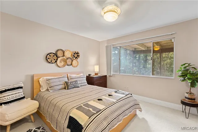 a bedroom with a bed and a chair