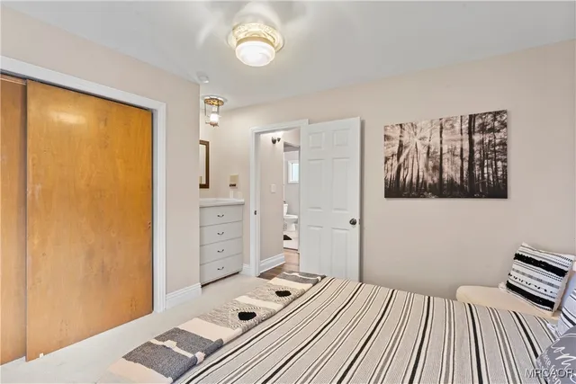 a view of a bedroom with bed and wooden floor