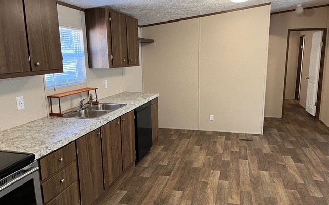 654 Burger Road Murphy, NC 28906 - Photo 12 of 33 a kitchen with a sink a cabinetry and a refrigerator