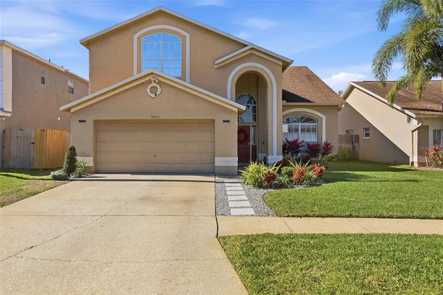 a front view of a house with a garden and plants