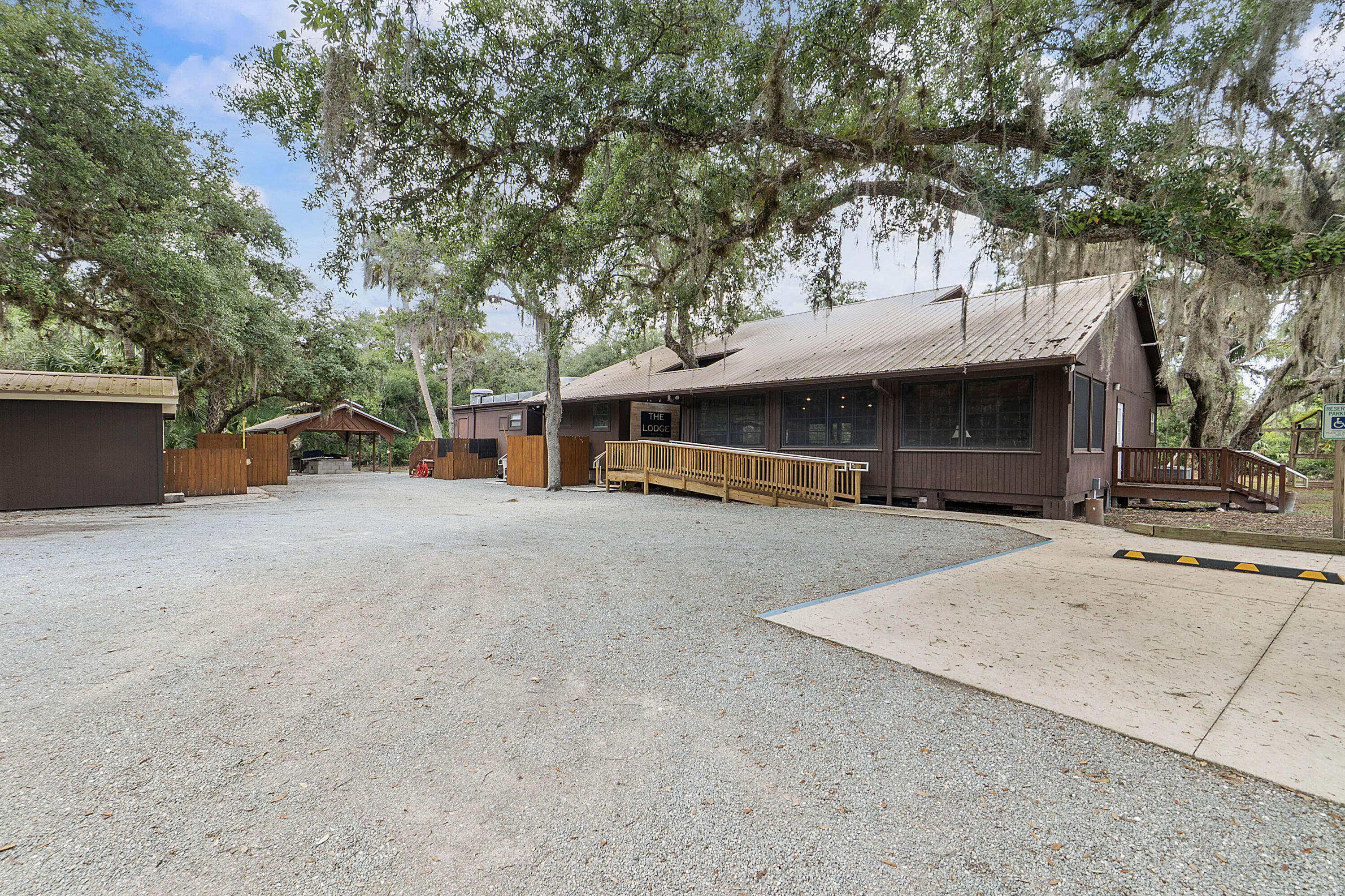 32801 Highway 441, Unit 64 Okeechobee, FL 34972 - Photo 119 of 138 a view of a house with large tree and wooden fence