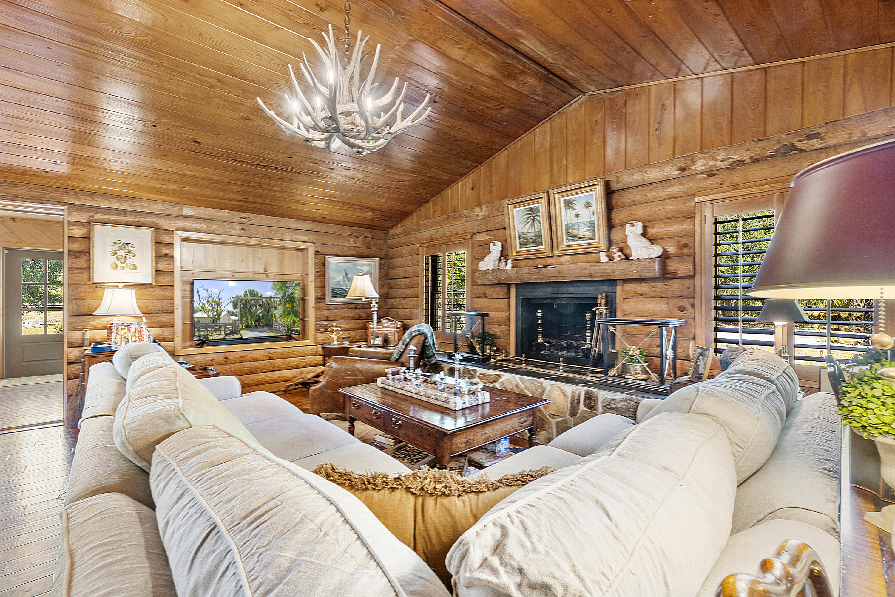 32801 Highway 441, Unit 64 Okeechobee, FL 34972 - Photo 16 of 138 a living room with furniture a fireplace and a large window
