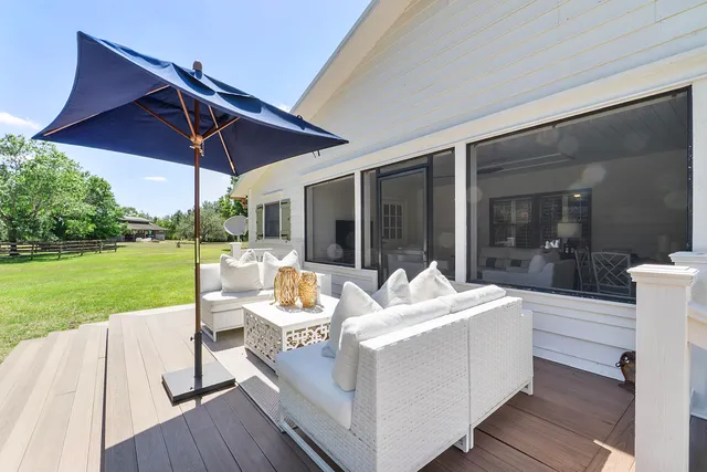 a backyard of a house with table and chairs