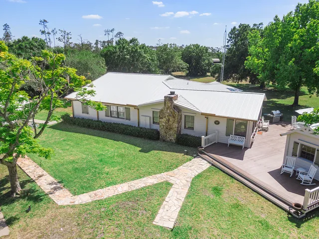 a living room with furniture a fireplace and a large window