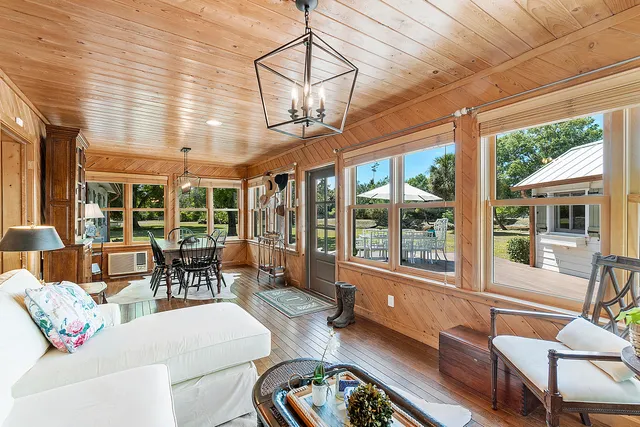 a dining room with furniture window and wooden floor