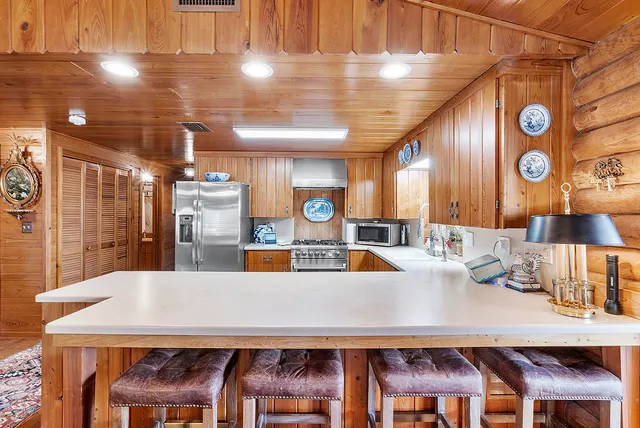 a view of a patio with couches chairs under an umbrella