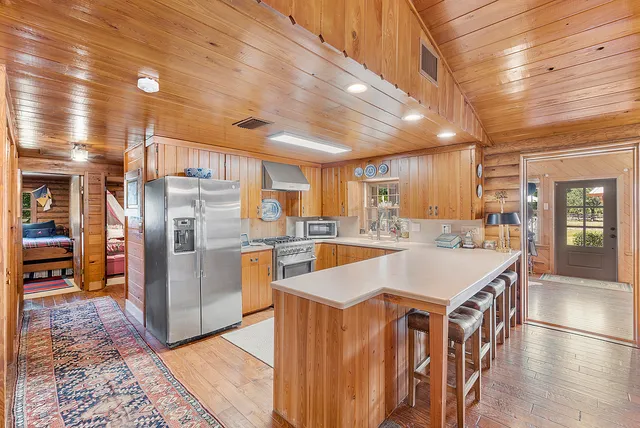 a bedroom with furniture and a large window
