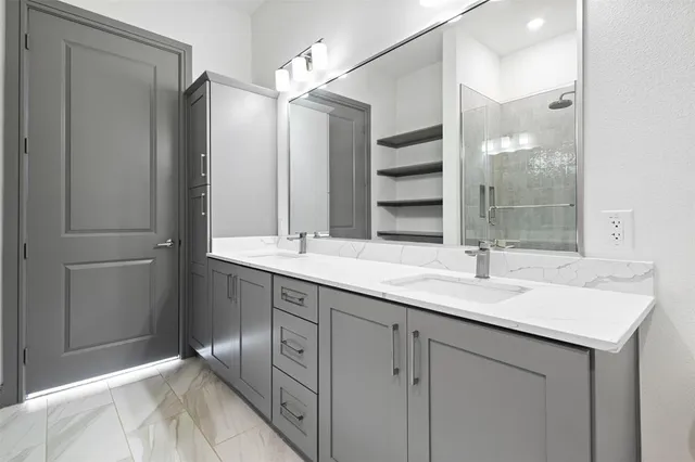 a bathroom with double sink and a mirror