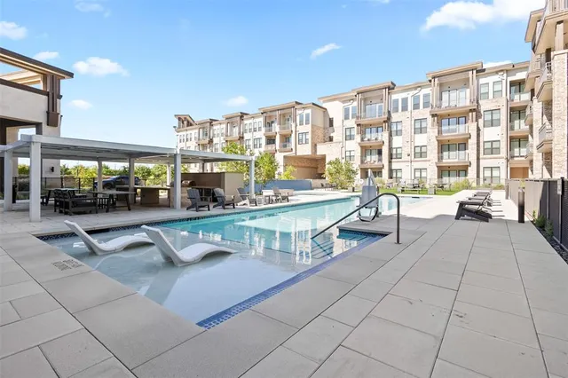 a swimming pool with outdoor seating and yard