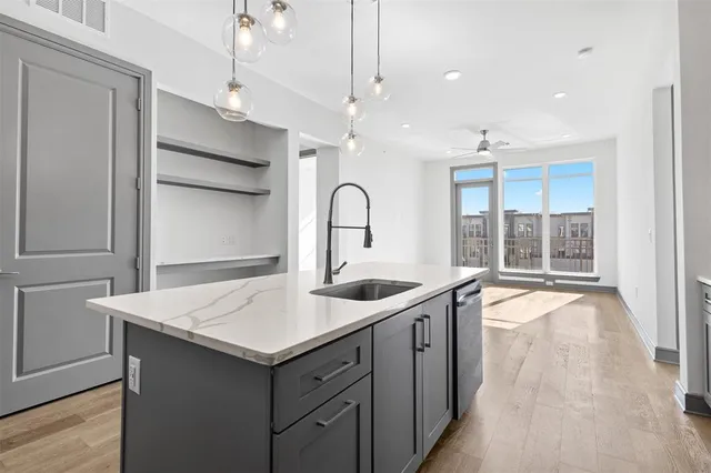 a kitchen with a sink stove and cabinets