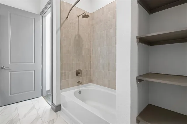 a bathroom with a bathtub and a shower