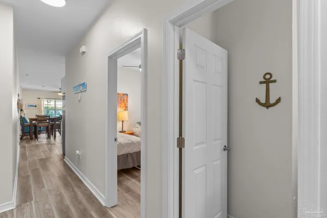 a view of a hallway with wooden floor and staircase
